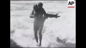 Surfing in Hawaii including dog on surfboard - 1954